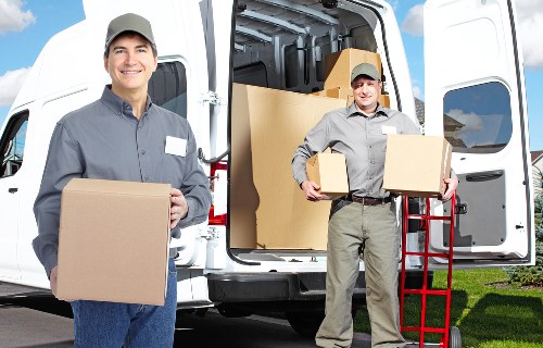 Local movers organizing boxes and fragile items during a home move